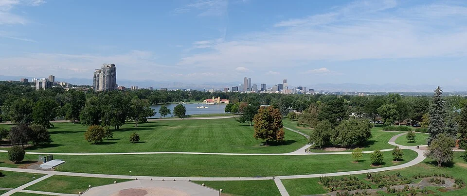 City Park lawns and lake with the Denver skyline beyond